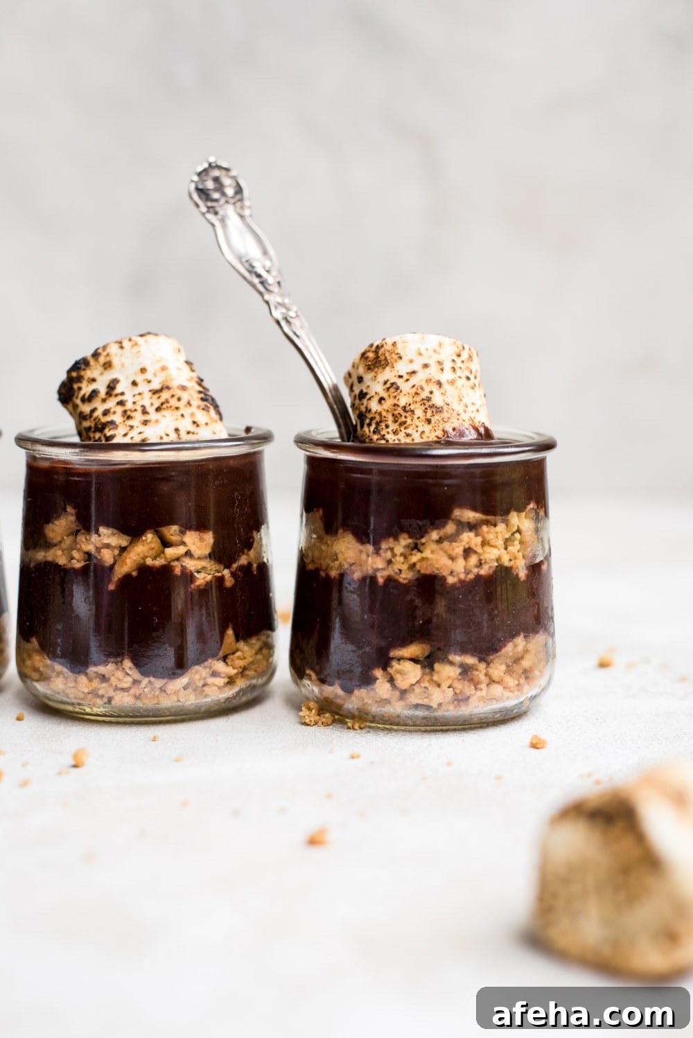s'mores pudding in jars with a spoon