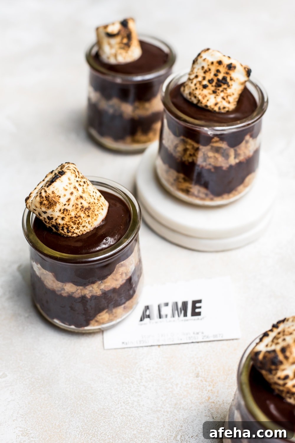 overhead s'mores pudding in jars on marble slabs