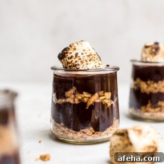 close up s'mores pudding in jar with toasted marshmallows