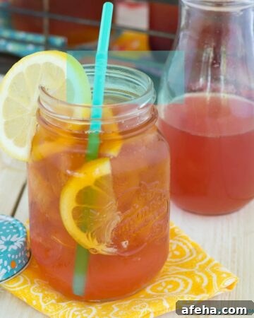 Peach Iced Tea in a mason jar with a straw.