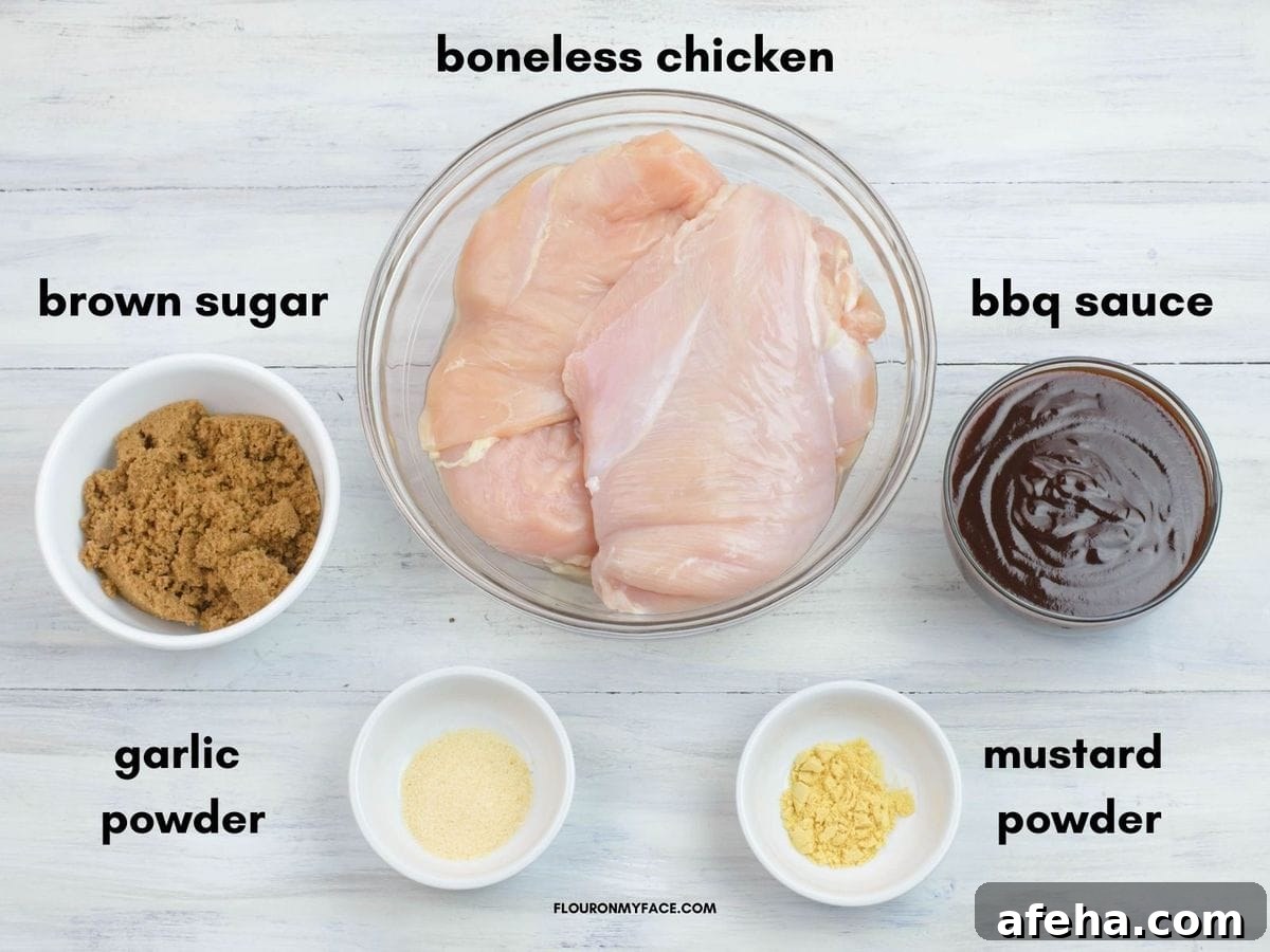 The 5 ingredients in individual bowl needed to make pulled chicken in a crock pot.