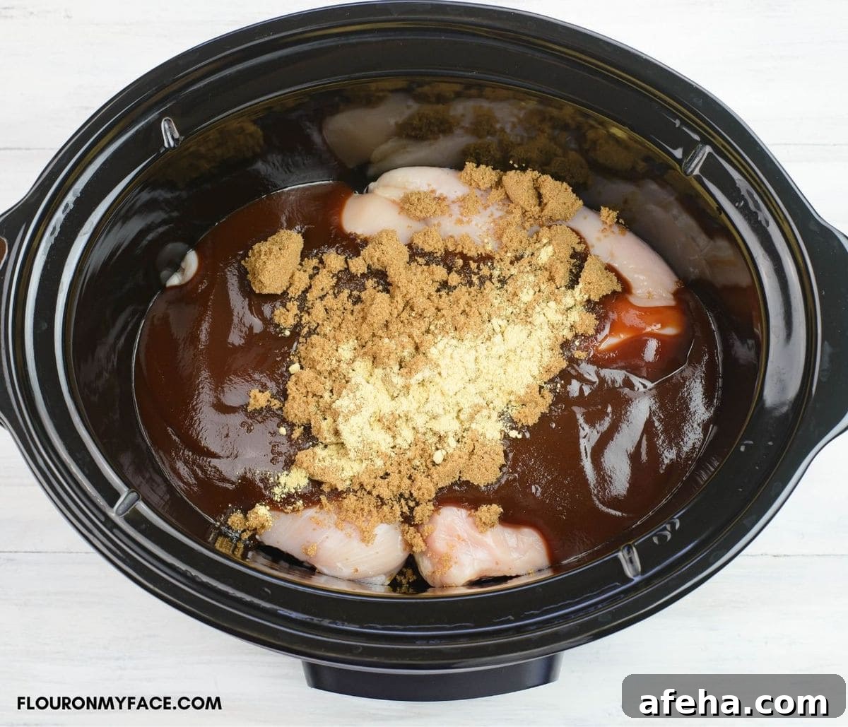Mixing the ingredients to make slow cooker pulled chicken in a crock pot.
