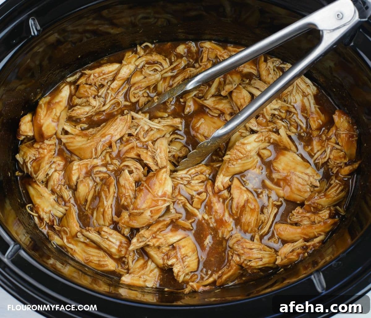 Shredded barbecued chicken in a crock pot.