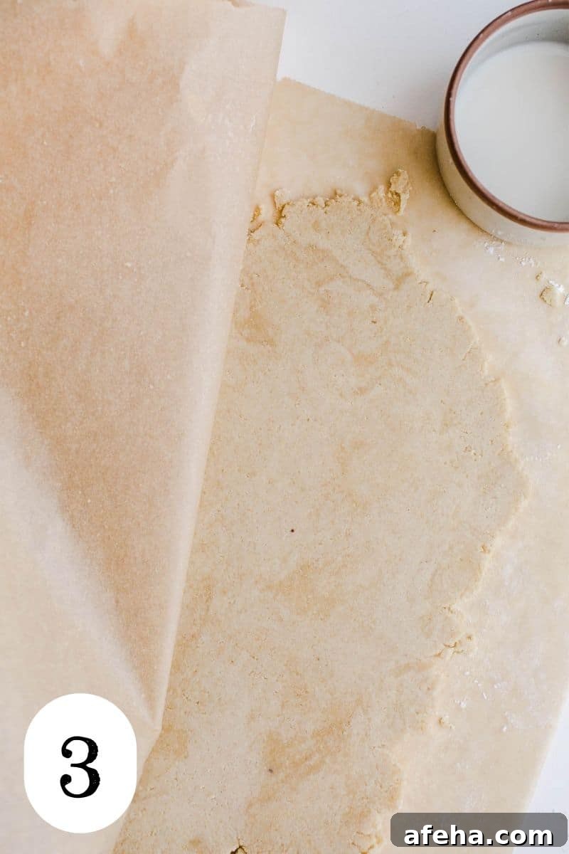 Rolled dough on a piece of parchment paper.