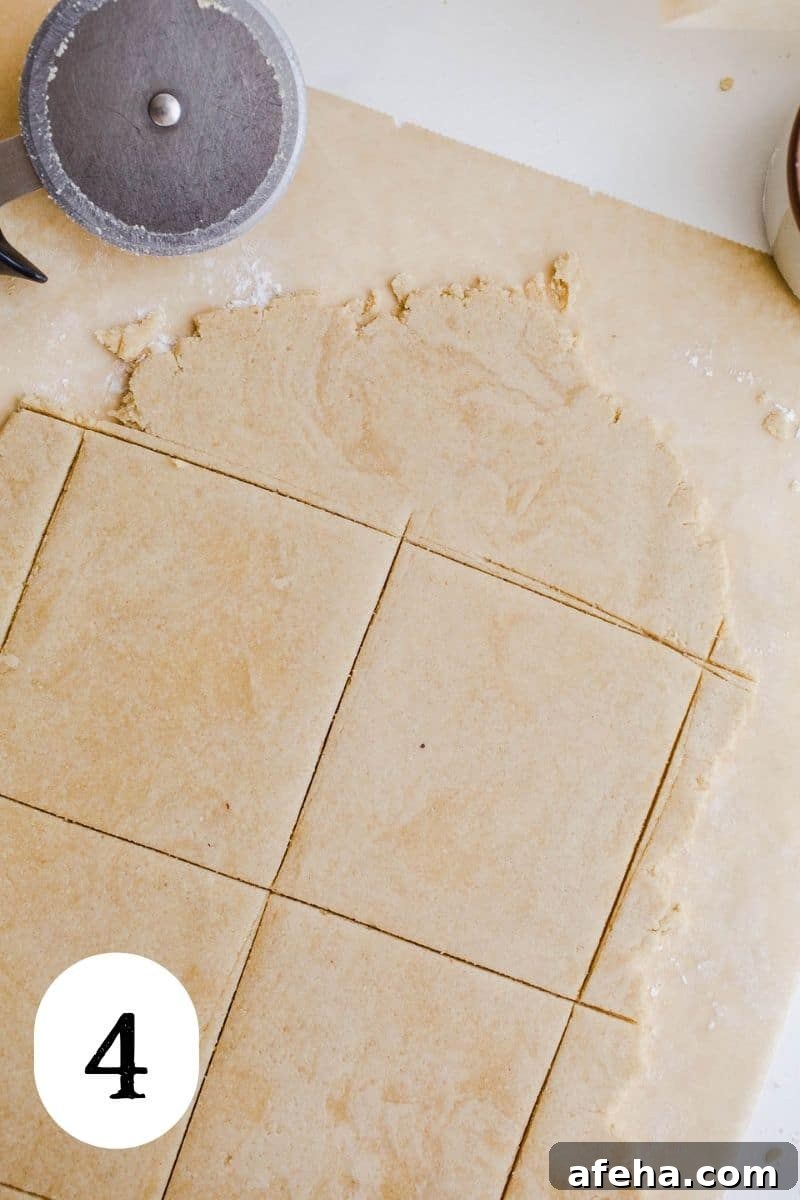 Sliced dough for pastries on a piece of parchment paper.