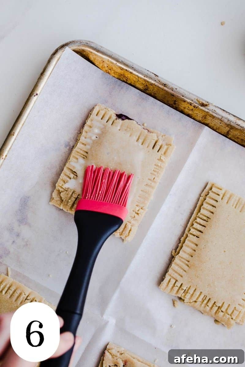 Washing a toaster pastry with almond milk.
