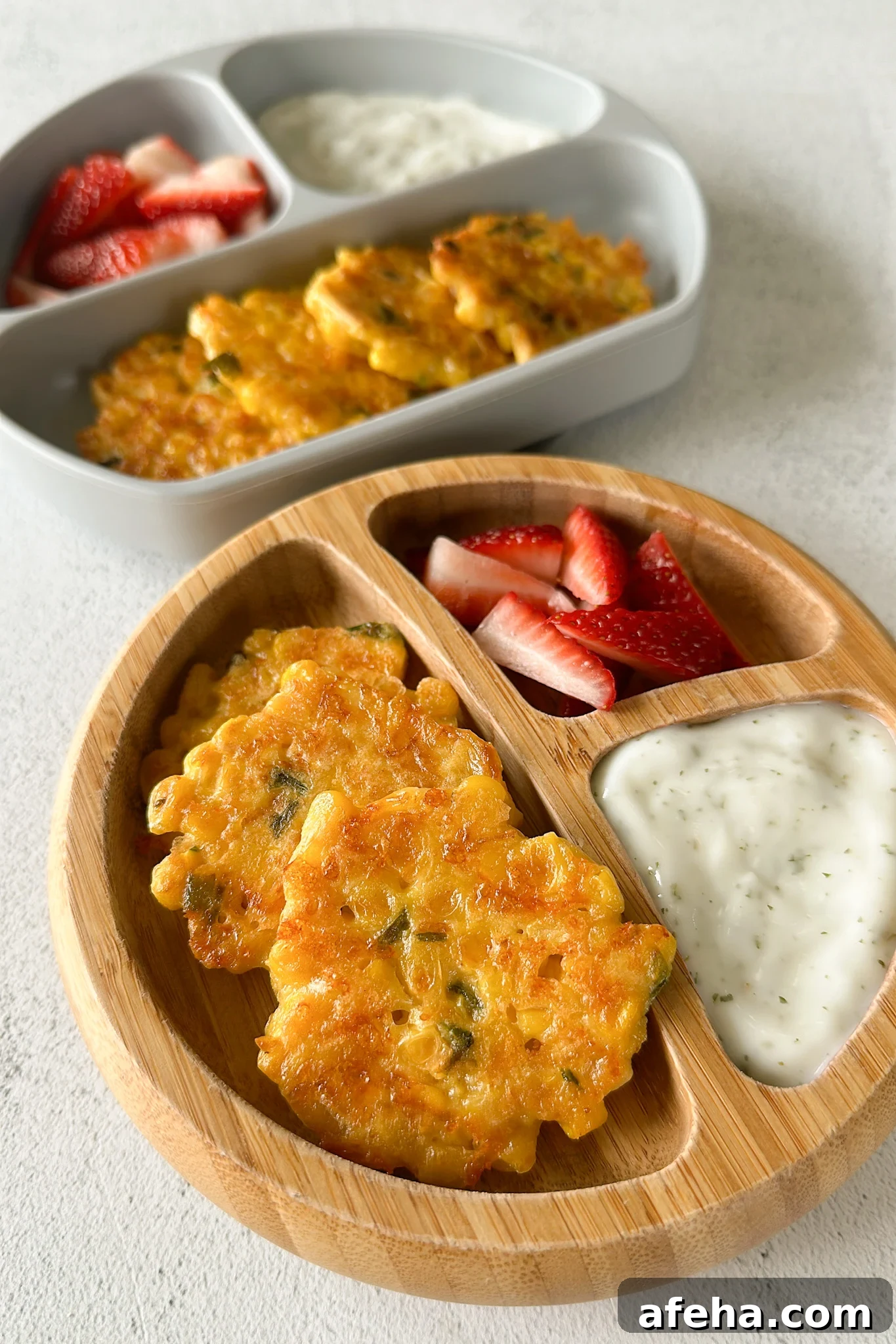 Sweet corn fritters served with strawberries and a dip.