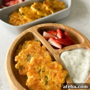 Sweet corn fritters served with strawberries and a dip.