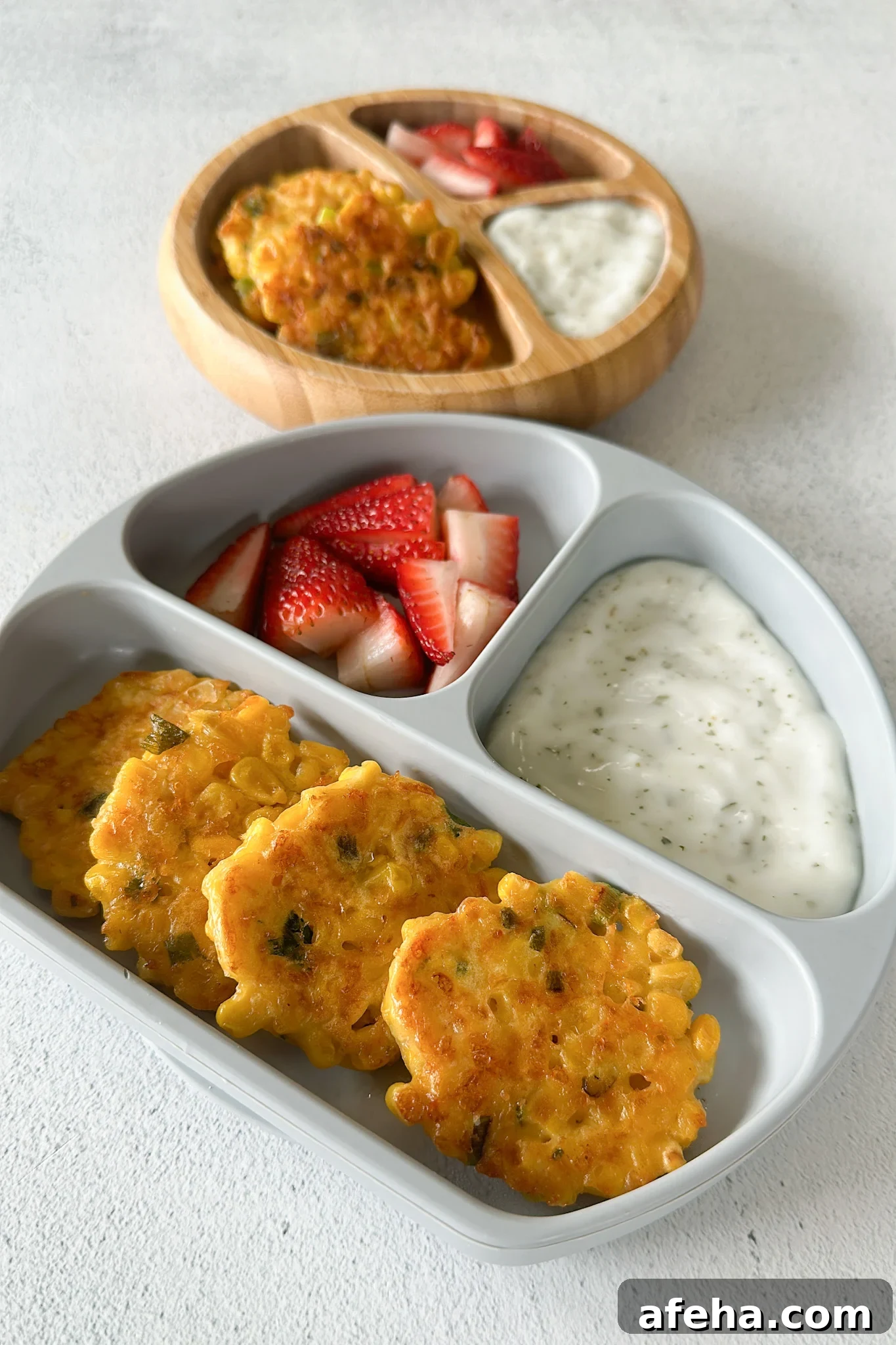 Sweet corn fritters served with strawberries and a dip.