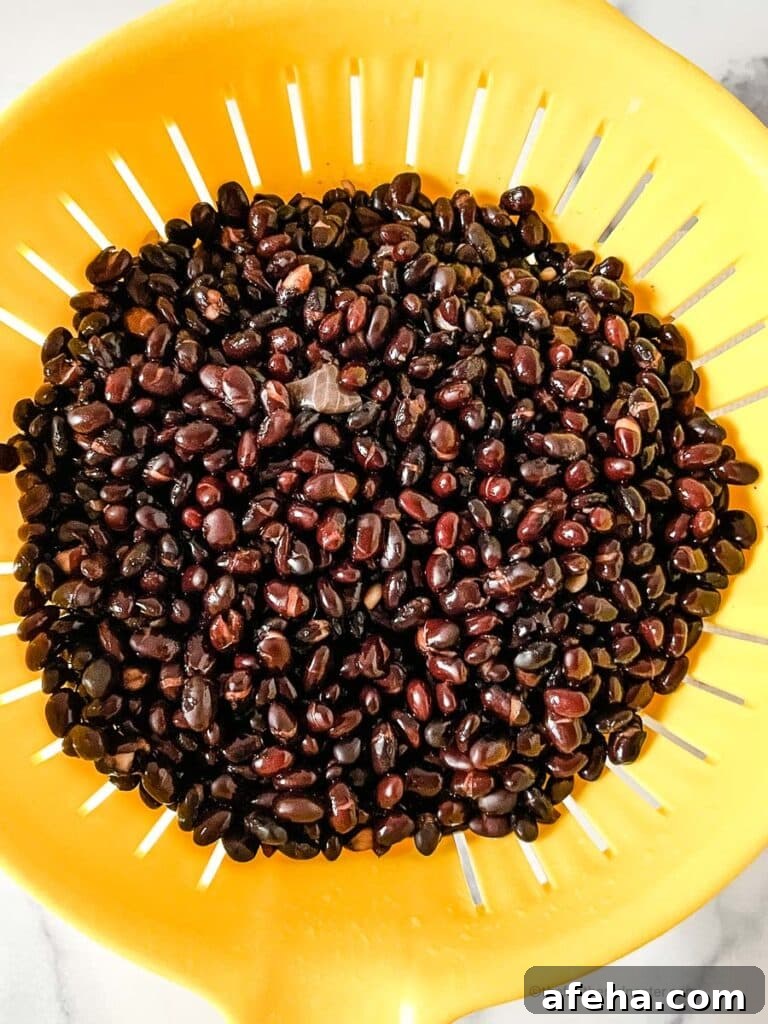 rinsing black beans in a colander.