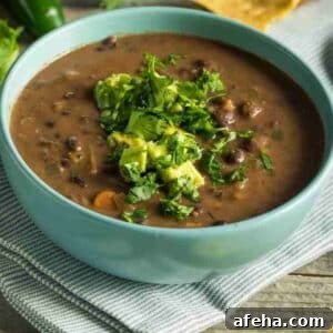 Instant Pot Black Beans made into a stew in a green bowl.
