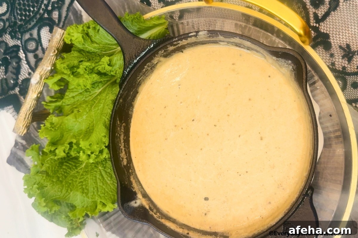 queso in a cast iron skillet next to lettuce