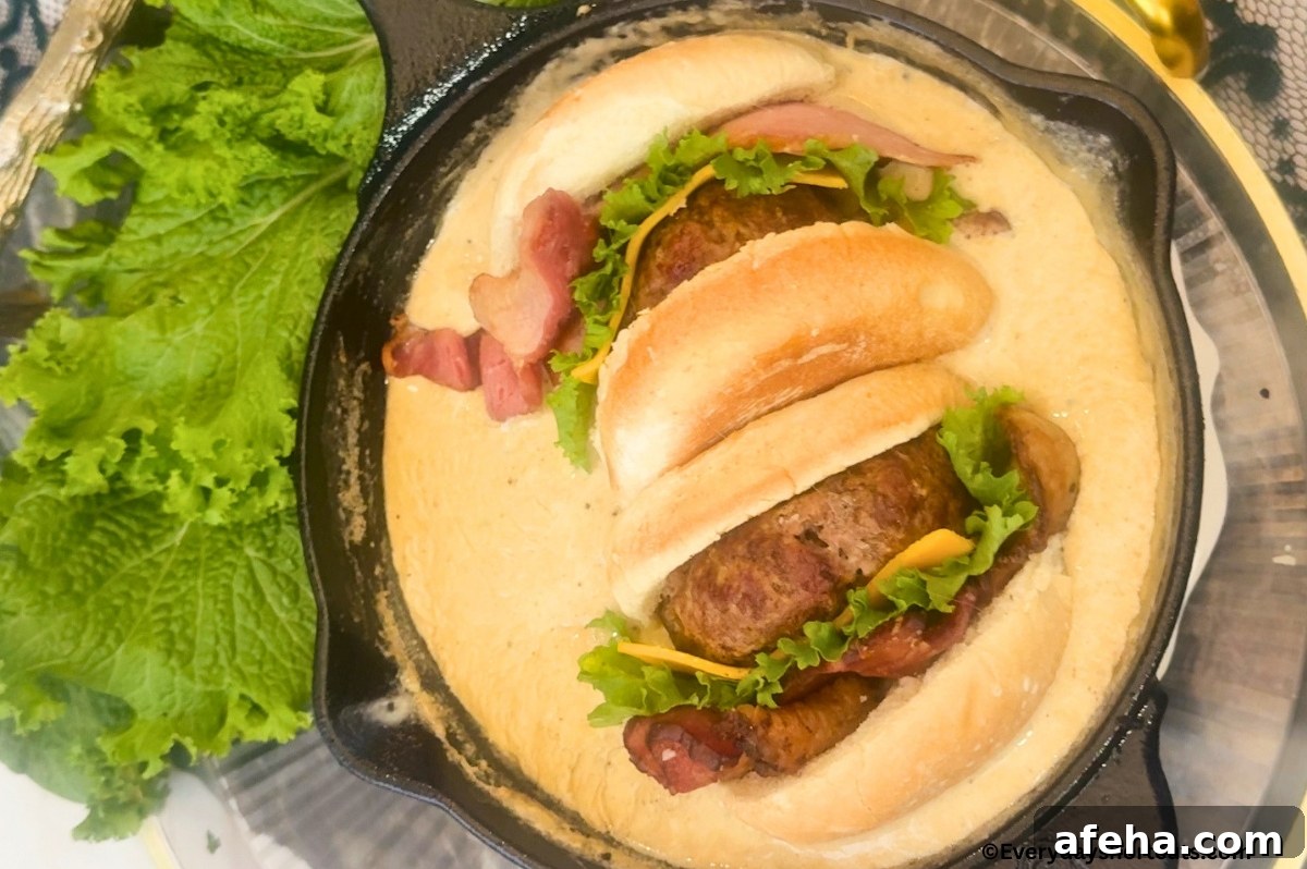 A cast iron skillet filled with queso and a burger on top