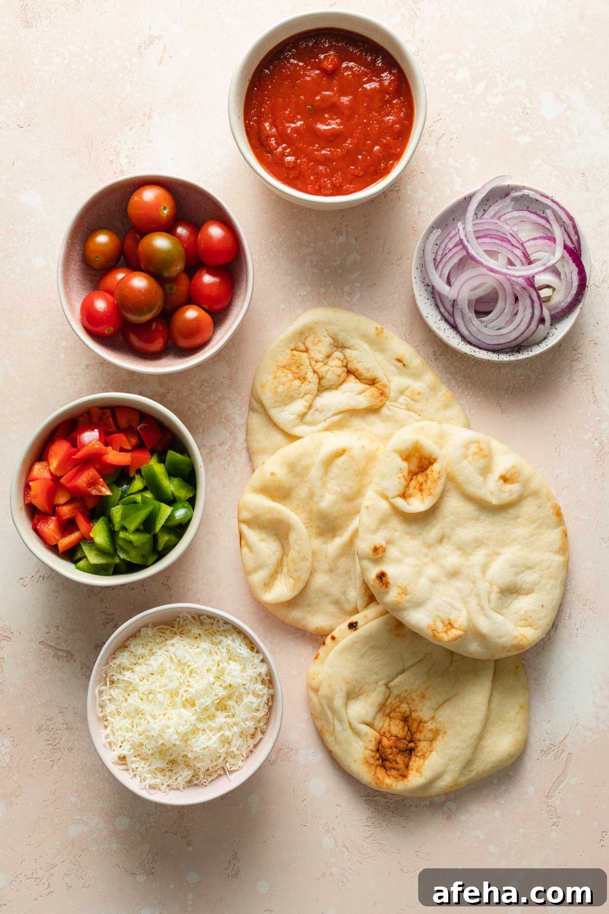 Mini Naan Bread Pizzas Made in the Air Fryer 3 Ingredients to make air fryer mini pizzas arranged individually.
