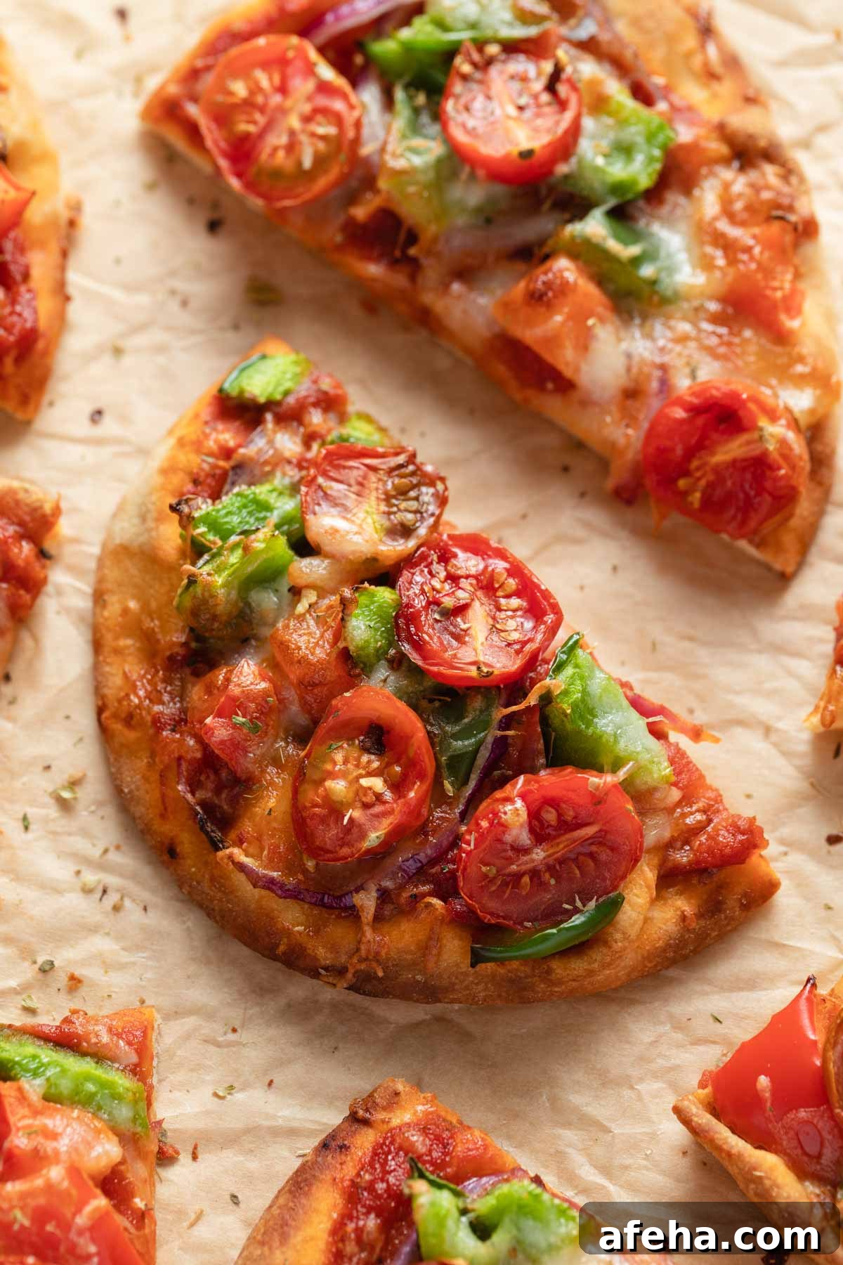 Mini Naan Bread Pizzas Made in the Air Fryer 7 Close up view of a slice of naan bread pizza.