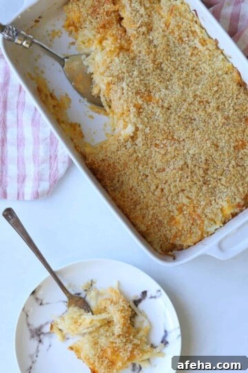casserole dish full of hash brown casserole and small plate with a serving