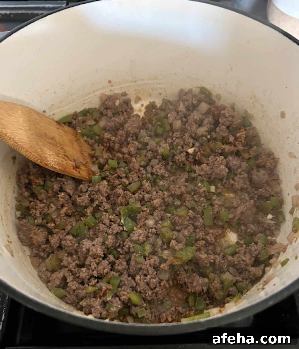 Ground beef filling cooking in dutch oven.