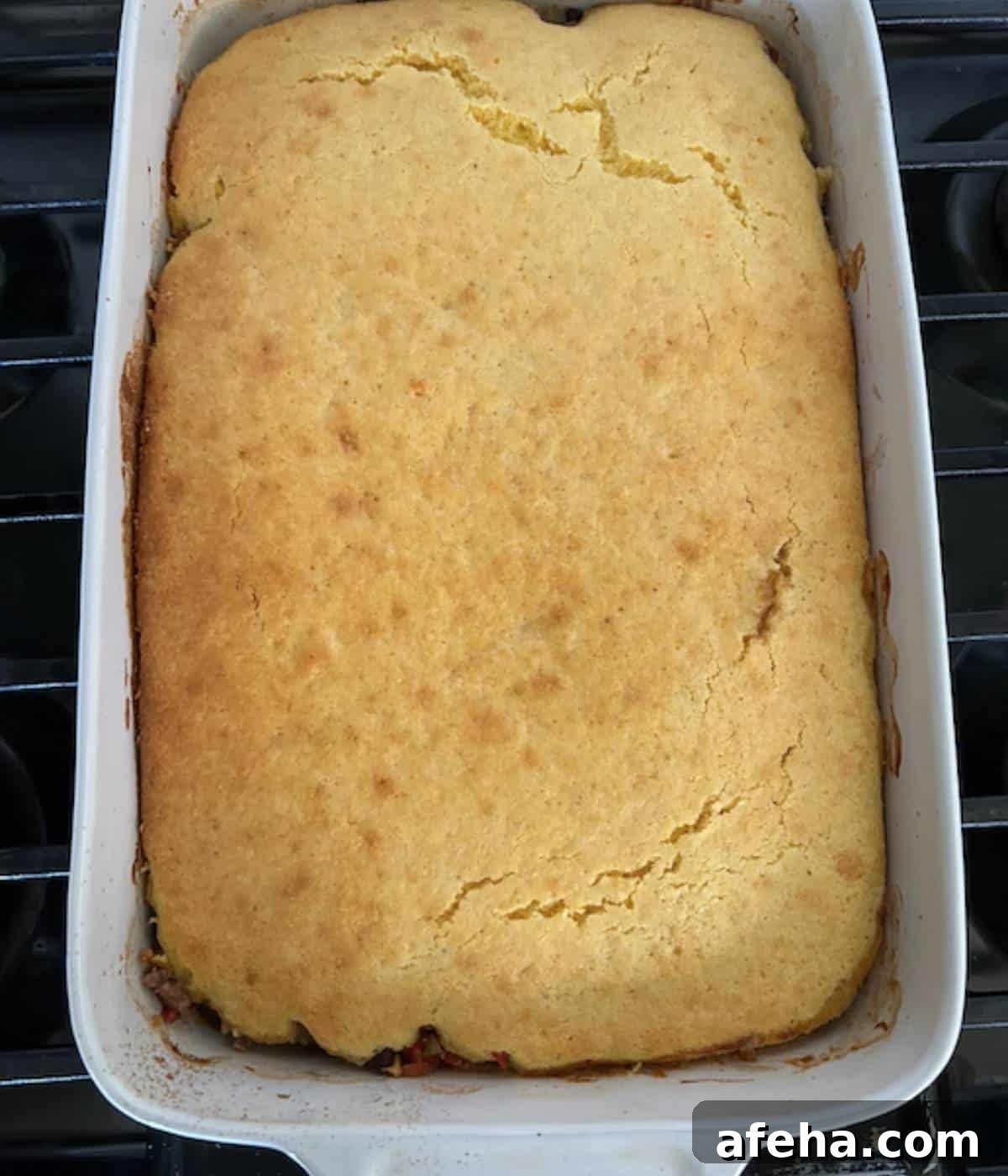 Baked cornbread casserole in dish.