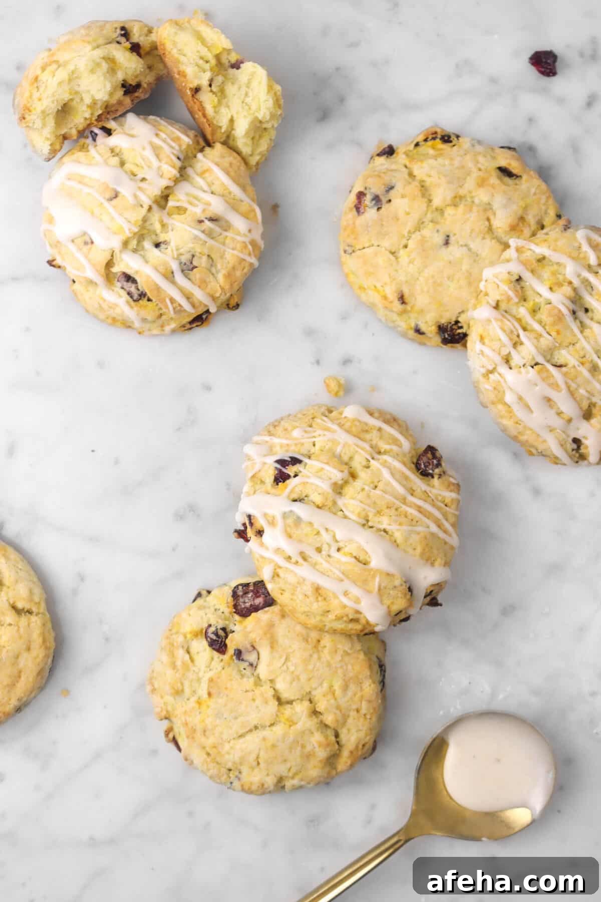 six scones on a marble counter with a gold spoon