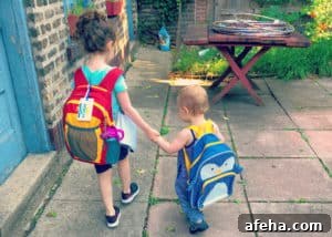 two kids with backpacks getting ready to go back to school