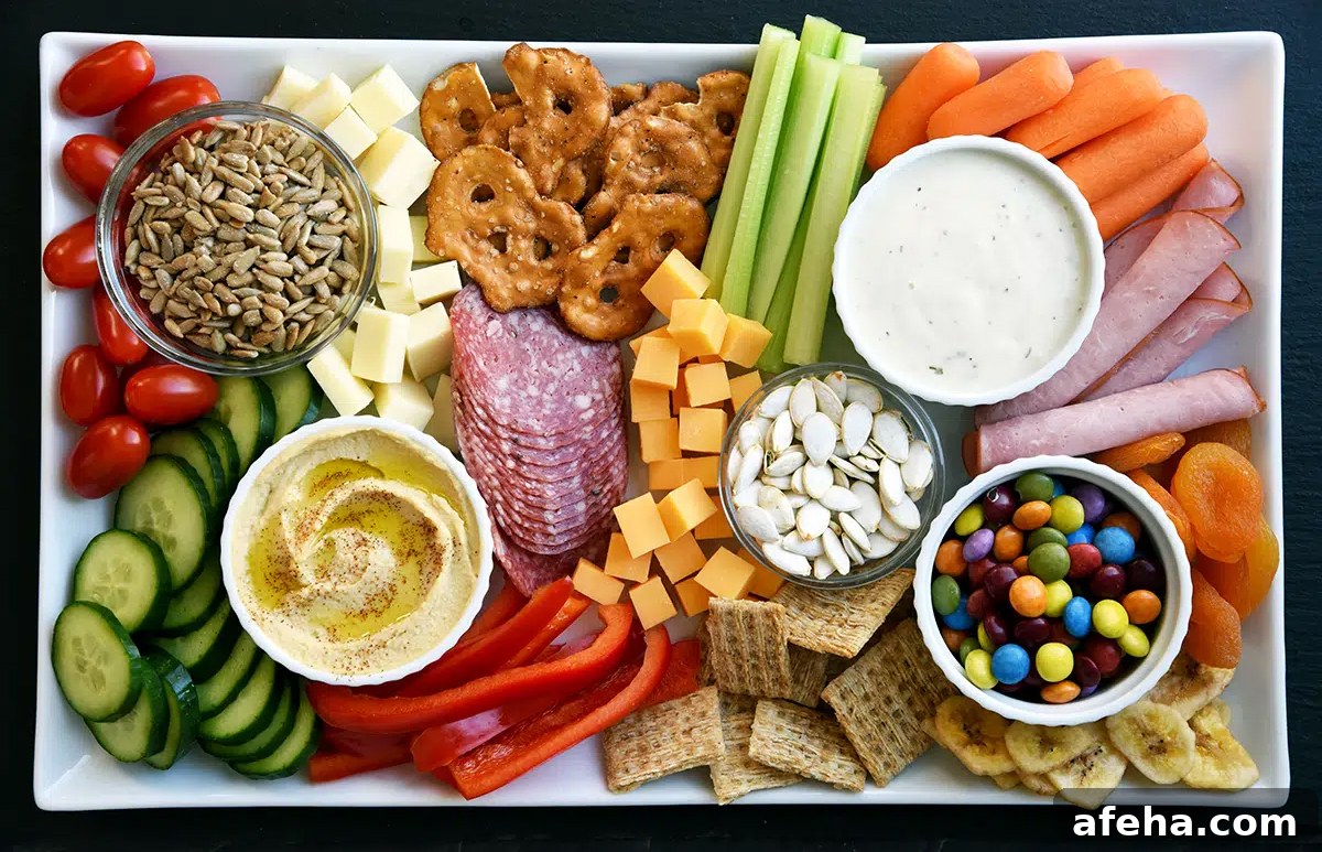 Whisking Mama presents pretzels, cucumbers, carrots, cheese, and meats on this kid friendly charcuterie board.