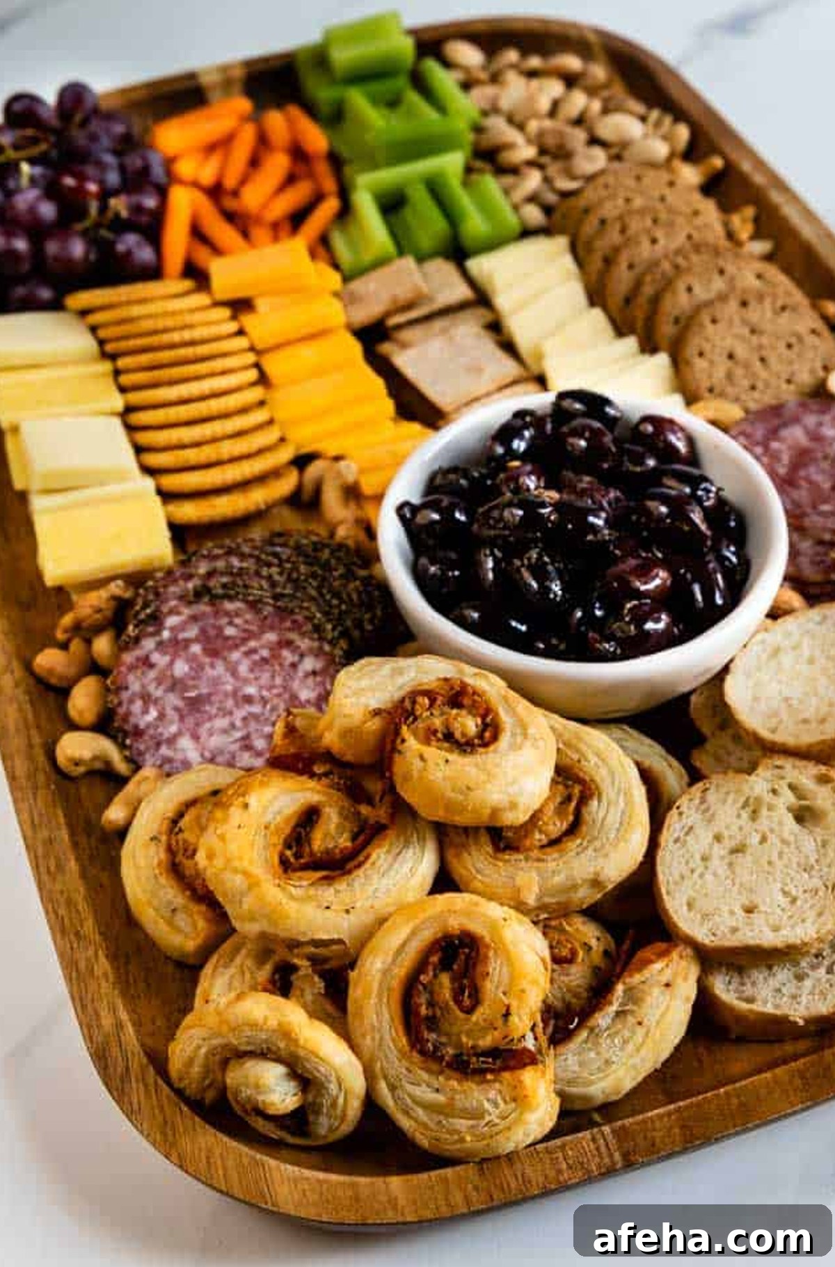 Easy Good Ideas board displays crackers, cheese, celery, carrots, meats, and grapes.