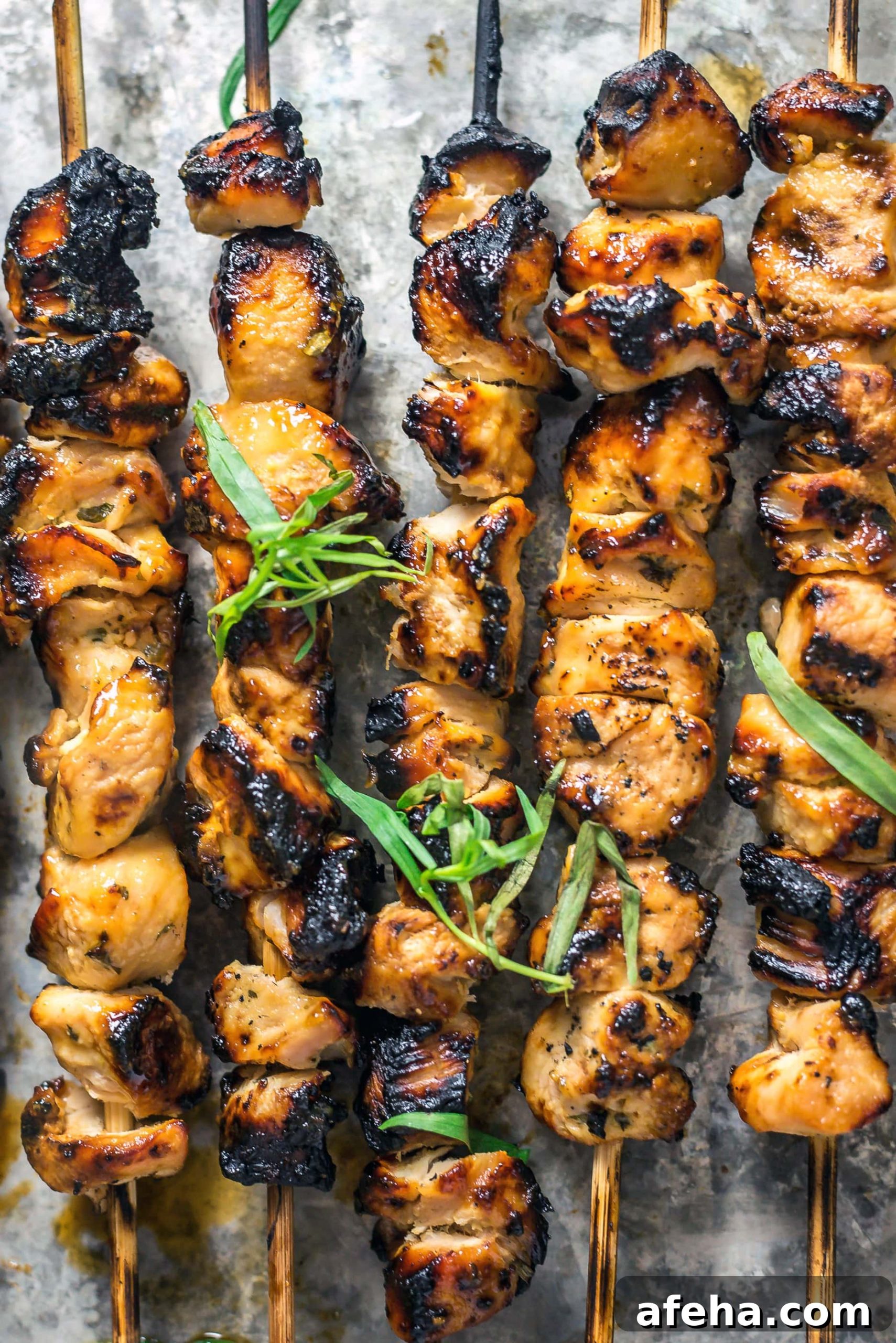 Close up view of lightly charred Tarragon Mustard Chicken Skewers