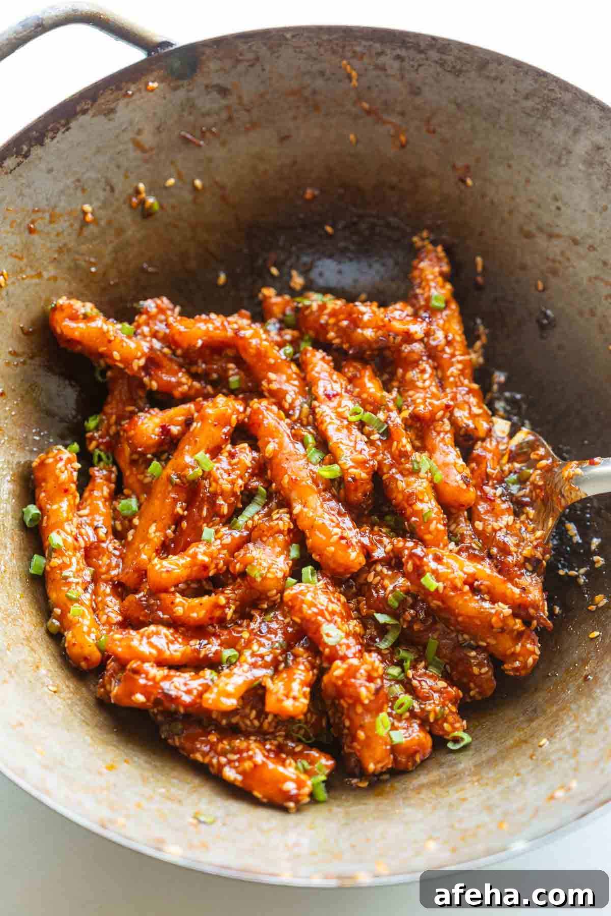 crispy honey chilli potatoes in a wok straight from the stove