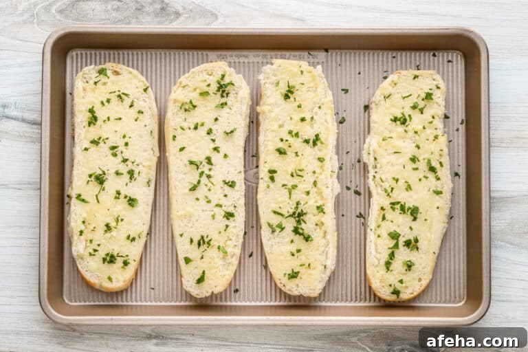 Spread garlic butter over the bread and sprinkle with chopped parsley.