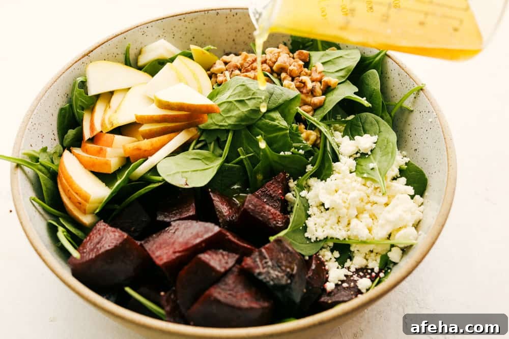 Pouring dressing over the bowl of salad.