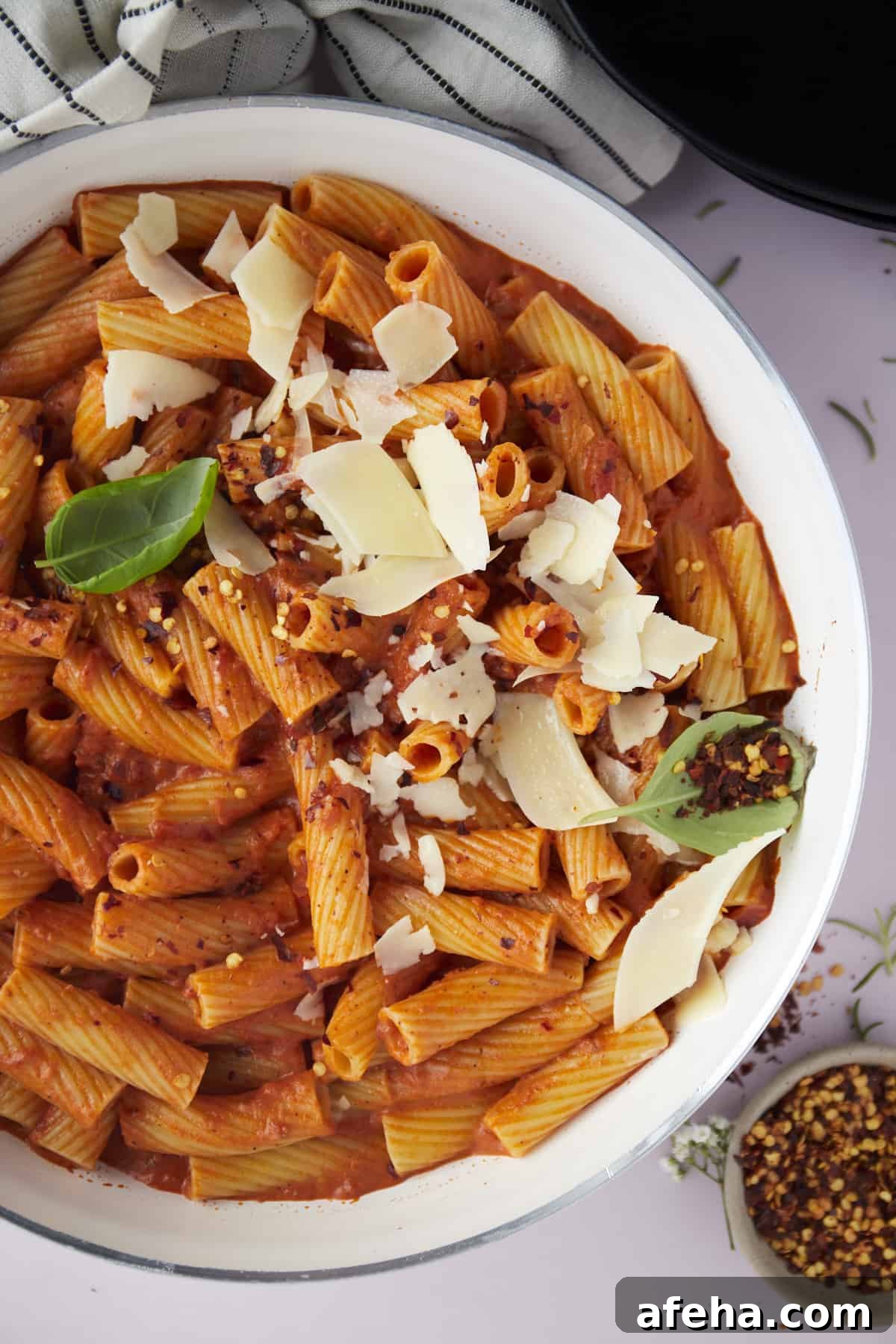 overhead image of a bowl of pasta topped with grated Parmesan.