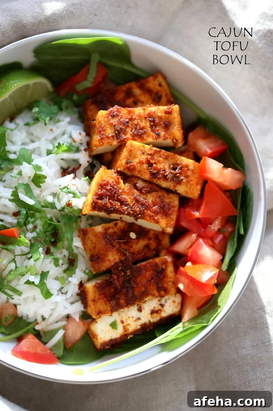 Cajun Tofu with Cilantro Lime Rice. Baked Cajun Spiced Tofu, over greens, cilantro lime rice, and tomatoes. Easy Spicy Bowl. Vegan Gluten-free Nut-free Recipe. Use Chickpea tofu to make soy-free. | VeganRicha.com