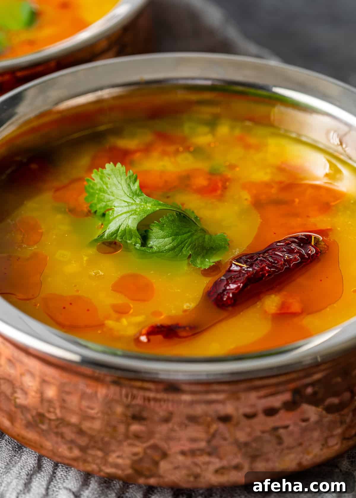 Creamy Dal Tadka Recipe: Authentic Indian Lentil Curry Guide 3 closeup side view: Dal Tadka in bowl on hand towel