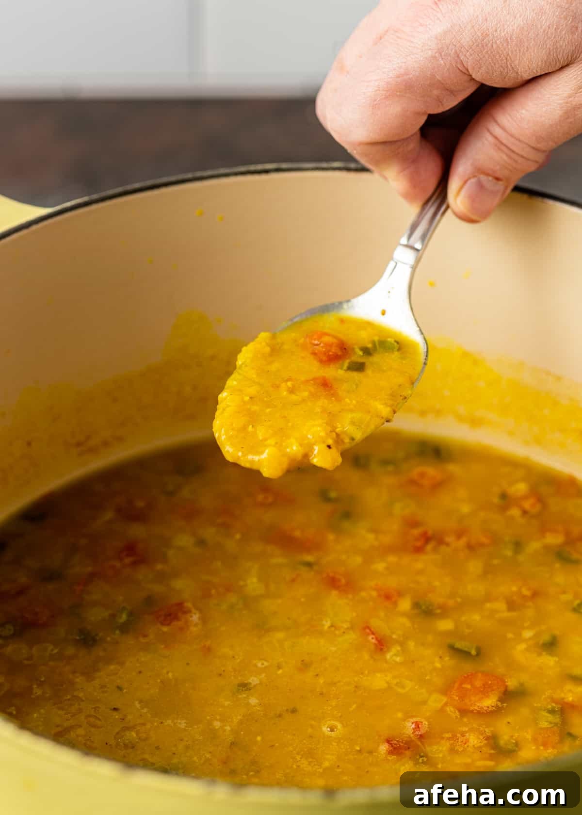 Creamy Dal Tadka Recipe: Authentic Indian Lentil Curry Guide 7 closeup: fingers getting a spoonful of Dal Tadka