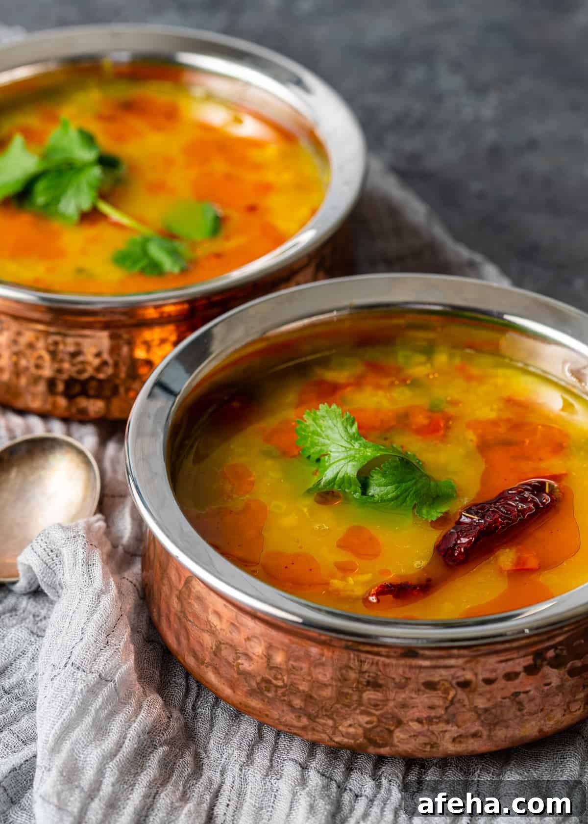 Creamy Dal Tadka Recipe: Authentic Indian Lentil Curry Guide 10 closeup sideview: Dal Tadka in bowls on hand towel