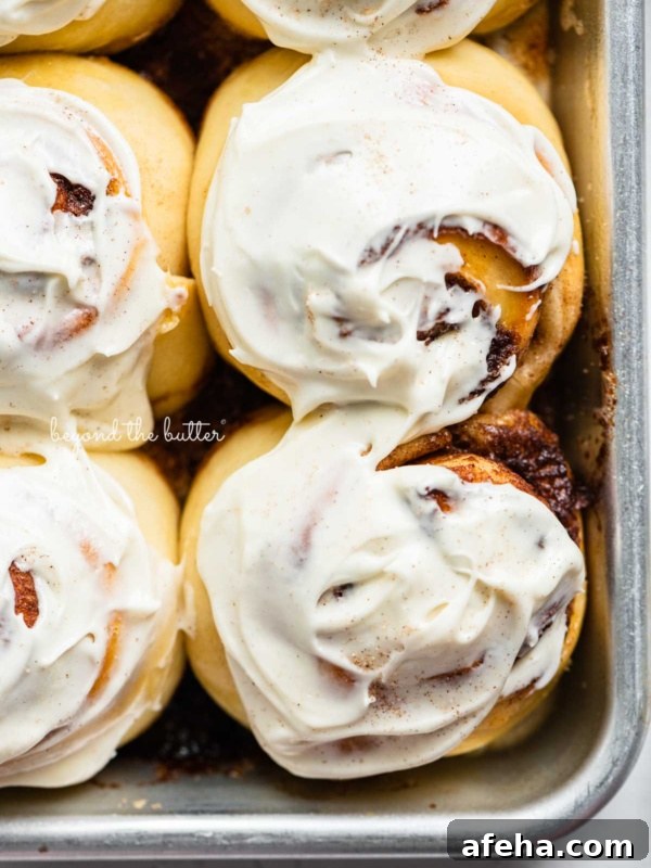 Frosted small batch cinnamon rolls on baking sheet.