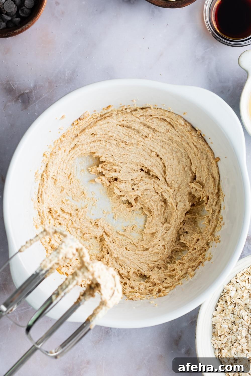 An overhead view of a large mixing bowl with butter and sugar creamed together.