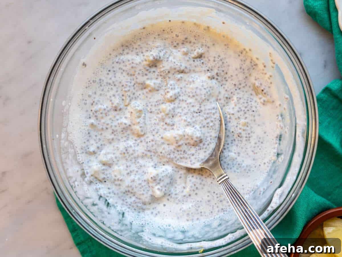 Step 4 Spoon stirring thick pineapple chia pudding before serving.