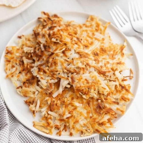Cooked hashbrowns on a plate.