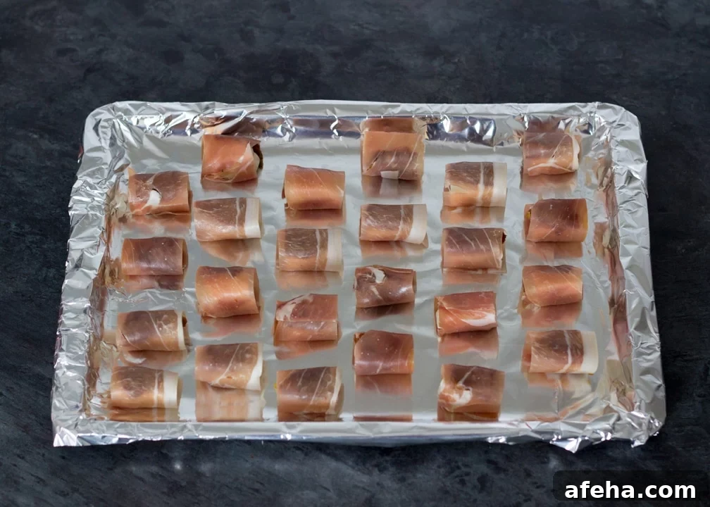 Party Snacks: Halloumi & sundried tomatoes wrapped in prosciutto on a baking tray
