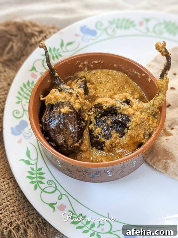 Hyderabadi Bagara Baingan: Tamarind-Spiced Eggplant 4 Two small aubergines served with curry in a small bowl