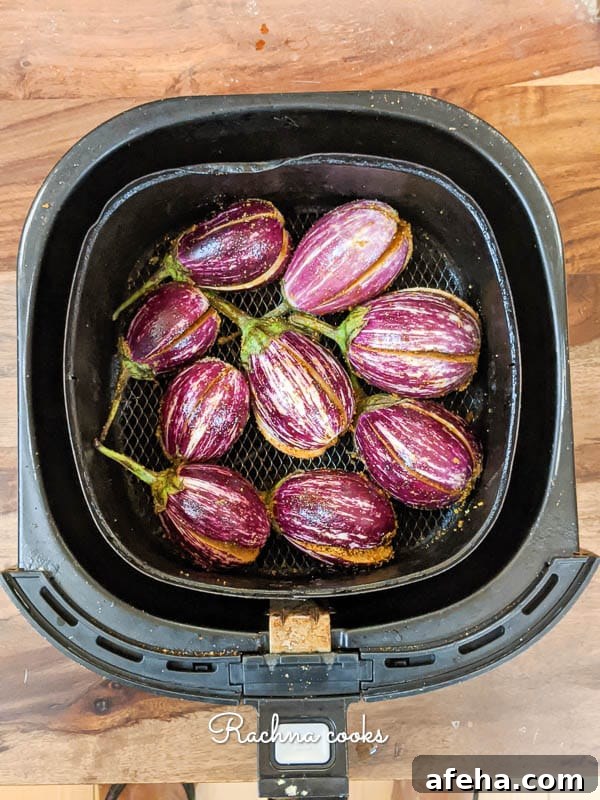 Hyderabadi Bagara Baingan: Tamarind-Spiced Eggplant 2 Stuffed aubergines kept for air frying in a air fryer basket