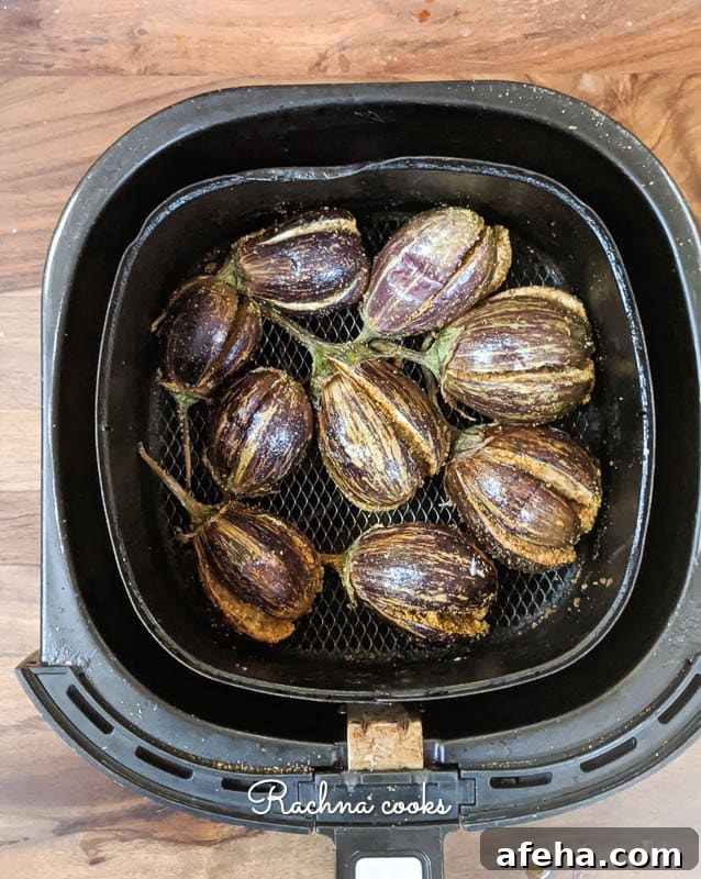 Hyderabadi Bagara Baingan: Tamarind-Spiced Eggplant 3 Aubergines after air frying in air fryer basket