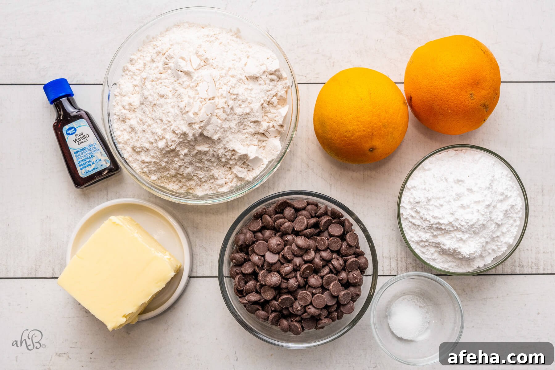 Vanilla extract, flour, butter, dark chocolate chips, powdered sugar, salt, and two oranges.