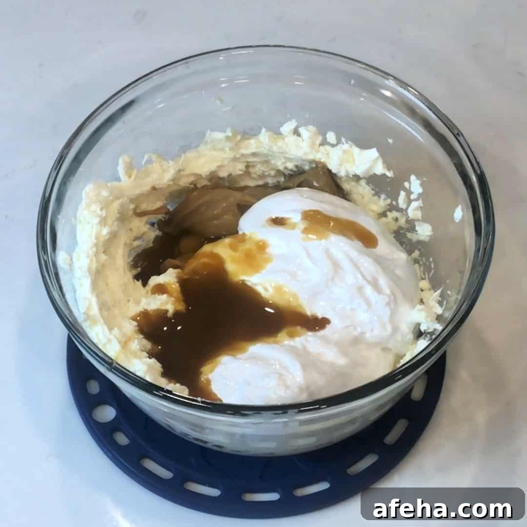 Add peanut butter, marshmallow cream and caramel sauce to the cream cheese.