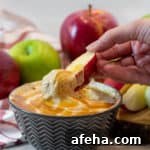 Creamy dip recipe for apples, bananas, other fruit or cookies, made of marshmallow fluff, cream cheese, peanut butter and caramel sauce ice cream topping.