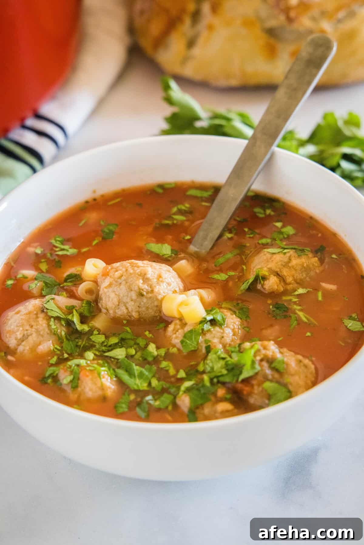 Hearty Italian Meatball Soup Recipe with Tender Meatballs 7 bowl of italian meatball soup with a spoon