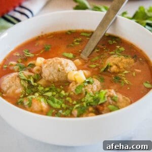 close up italian meatball soup in a bowl