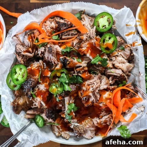 Top shot of barbecue pork shredded with jalapenos and barbecue sauce.