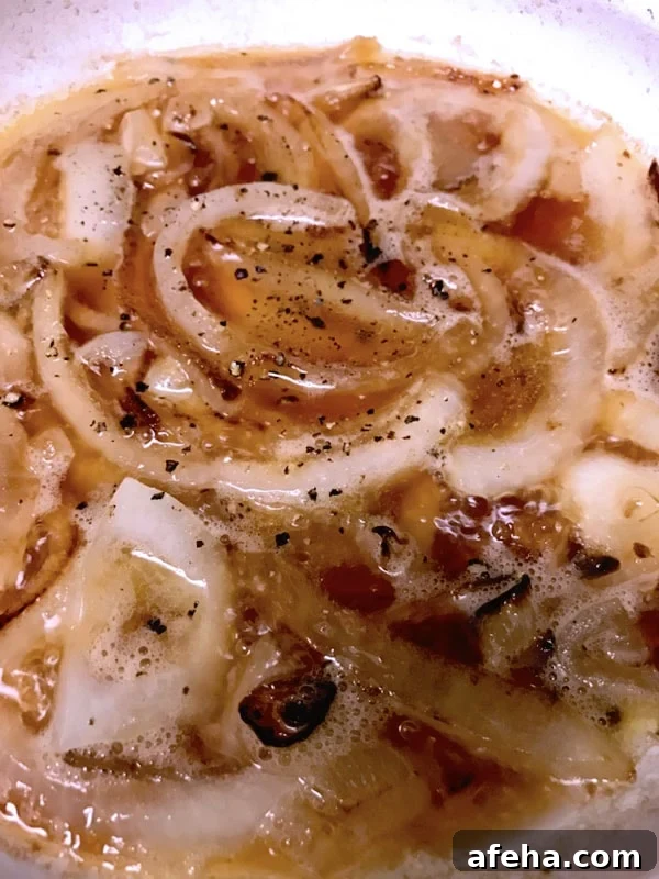Sliced onions caramelized with beer on white plate